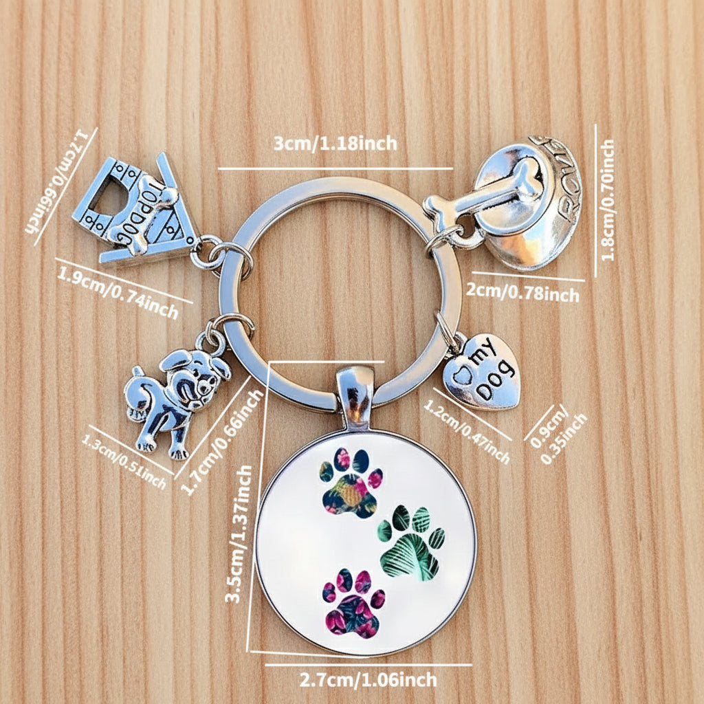 Keychain with paw print charm and measurement details on a dark surface